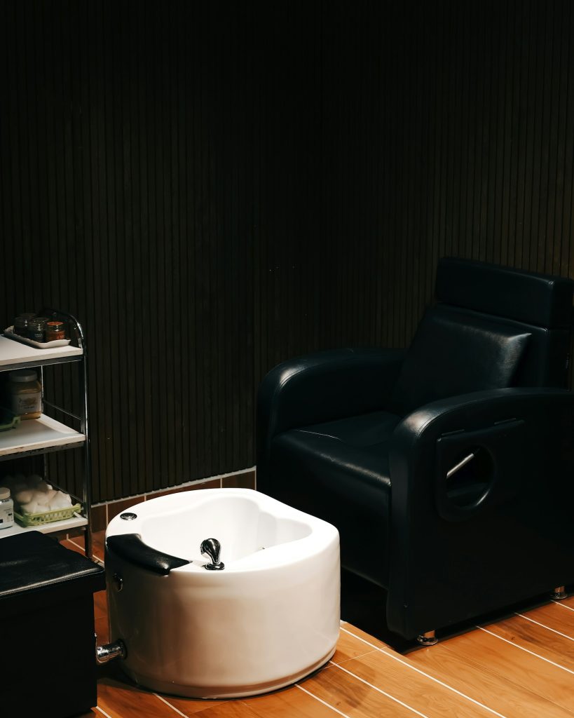 Treatment chair beside a clean white foot bath in the Sole Wellness foot care studio in Buffalo, New York